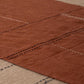 Hand-stitched linen table runner in eucalyptus terracotta draped over a wooden table, showing the full length and hem stitch detail