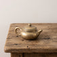 The Little Pot miniature solid brass teapot with a lift-off lid and aged speckled patina
