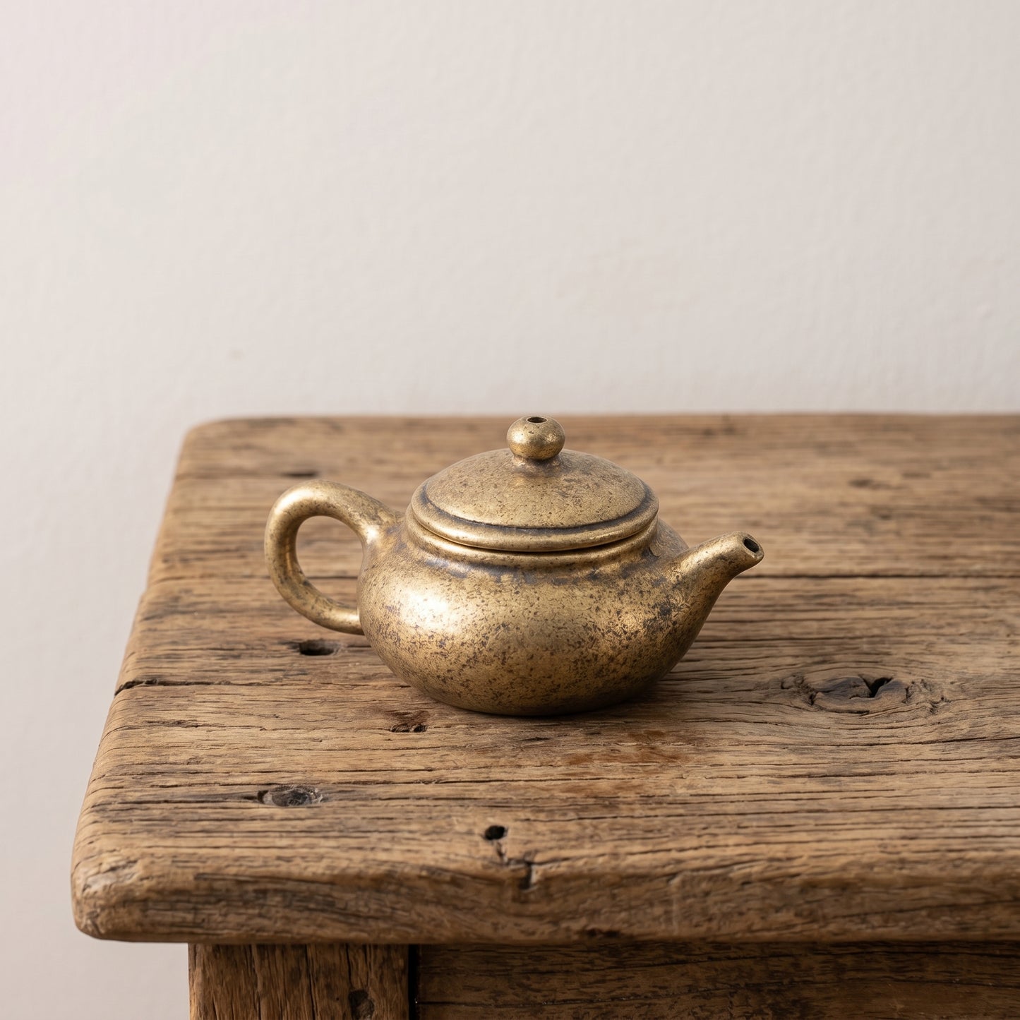 The Little Pot miniature solid brass teapot with a lift-off lid and aged speckled patina