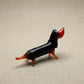 The Little Sausage miniature lampworked glass dachshund figurine in black and orange solid glass, handcrafted in L'viv Ukraine by Glass by Iness, from WILLAGE