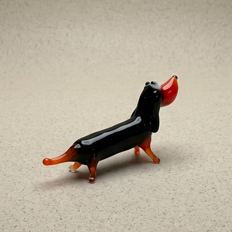 The Little Sausage miniature lampworked glass dachshund figurine in black and orange solid glass, handcrafted in L'viv Ukraine by Glass by Iness, from WILLAGE