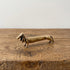 The Long Fellow miniature solid brass dachshund figurine stretched long with draped ears, warm brass finish