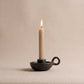 Longpi black pottery chamberstick candle holder with lit taper candle, handcrafted by the Tangkhul tribe in Manipur India, from WILLAGE