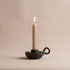 Longpi black pottery chamberstick candle holder with lit taper candle, handcrafted by the Tangkhul tribe in Manipur India, from WILLAGE