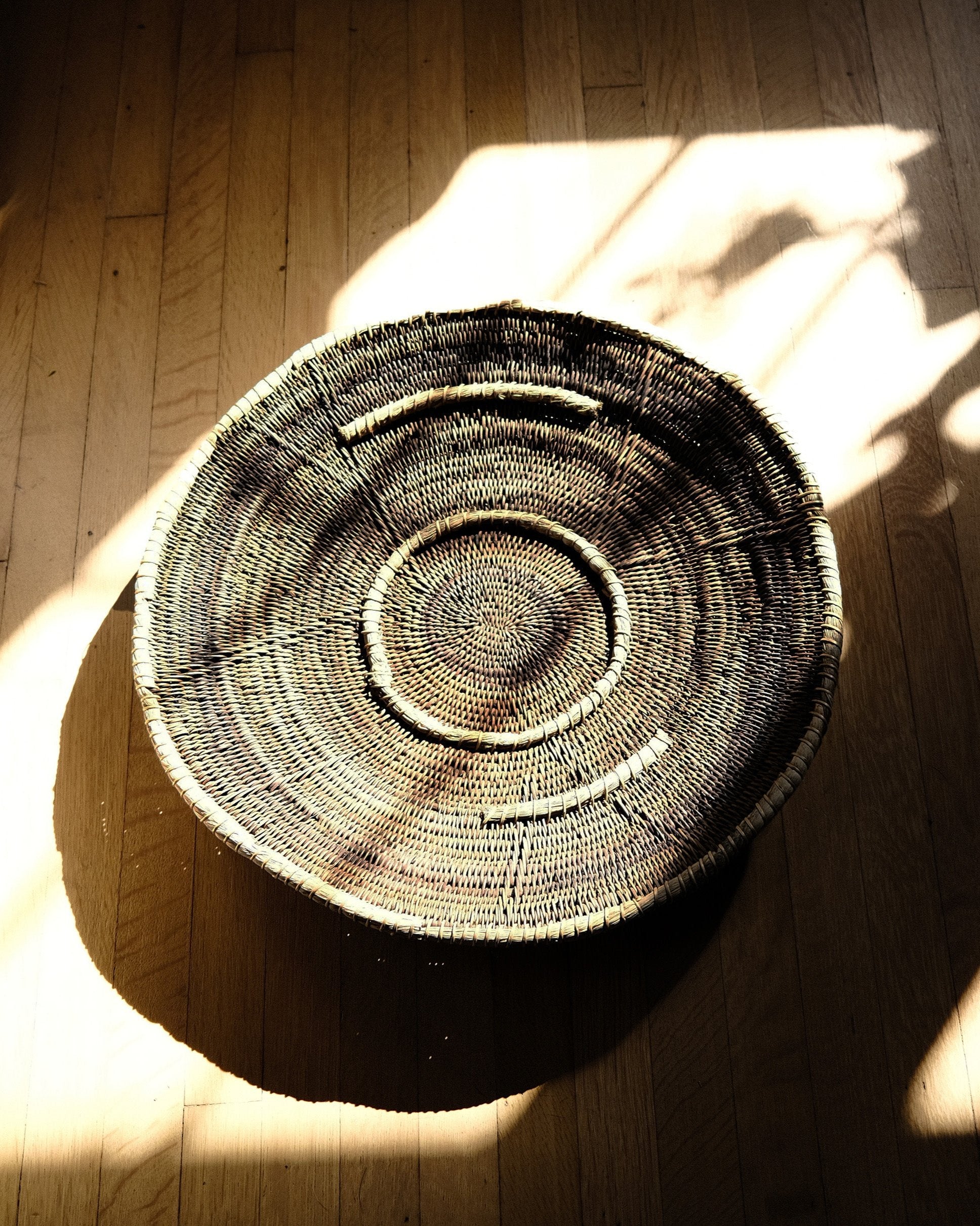 Close-up of vintage Makenge basket showing raised grass pattern and natural root-dyed colors, from WILLAGE
