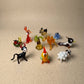 The Farmyard set of 10 miniature lampworked glass figurines including cow, rooster, sheep, lobster, horse, frog, palm tree, penguin, cat, and turtle, handcrafted by Glass by Iness in L'viv Ukraine