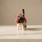 Hand-felted calico cat soft toy with ginger, black and cream wool patches, big eyes and a striped tail, made in Nepal