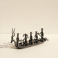 Side view of The Music Boat Bastar wrought iron sculpture showing full length of boat and individual forged musician figures
