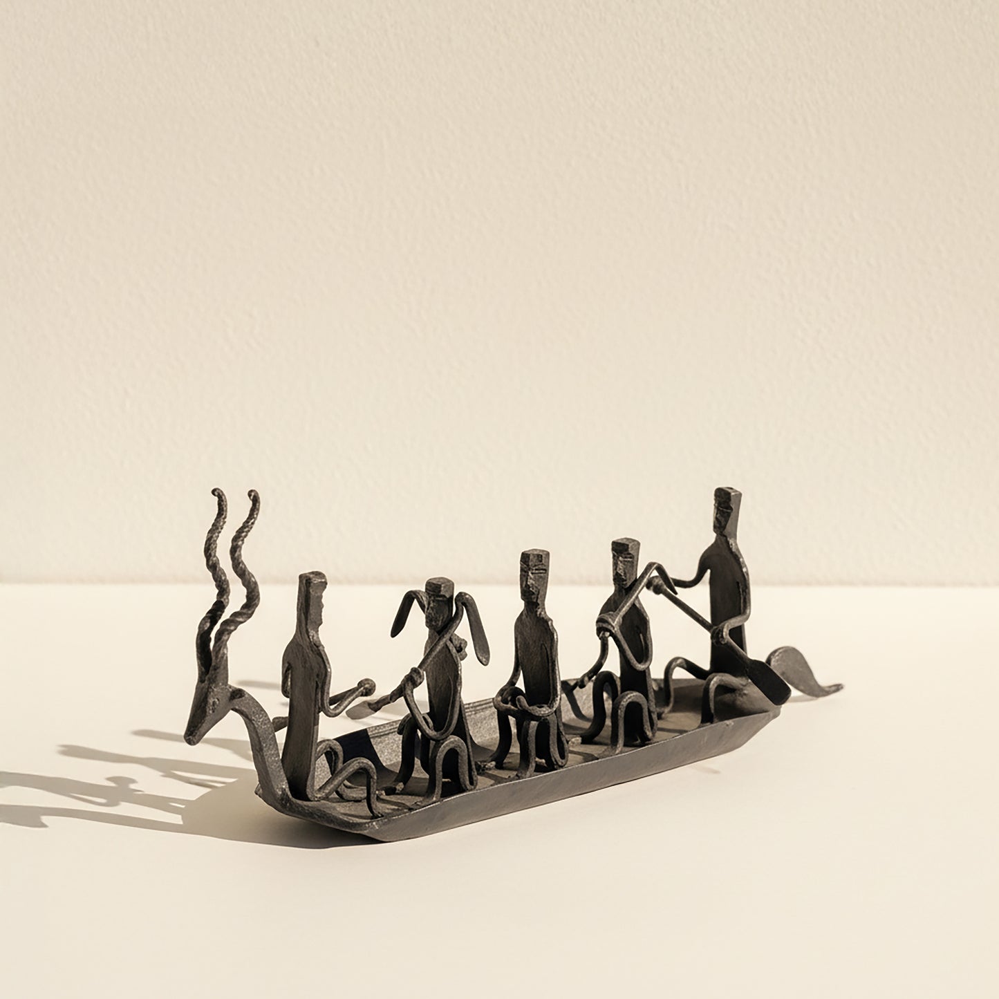 Side view of The Music Boat Bastar wrought iron sculpture showing full length of boat and individual forged musician figures
