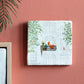 My Favorite Spot Storytile displayed on a warm-toned wall showing illustration of a person with cats on a sunny balcony, hand-baked ceramic by Marga van Oers in the Netherlands, from WILLAGE