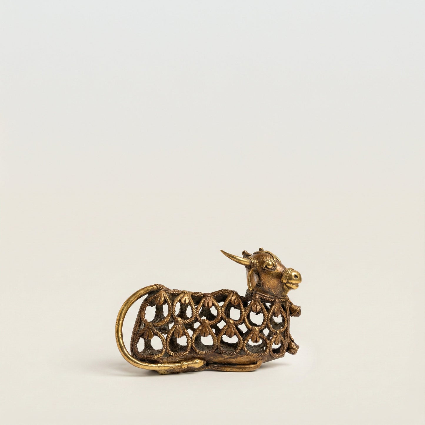 Side view of Nandi Dhokra bull sculpture showing full form and cast metal texture