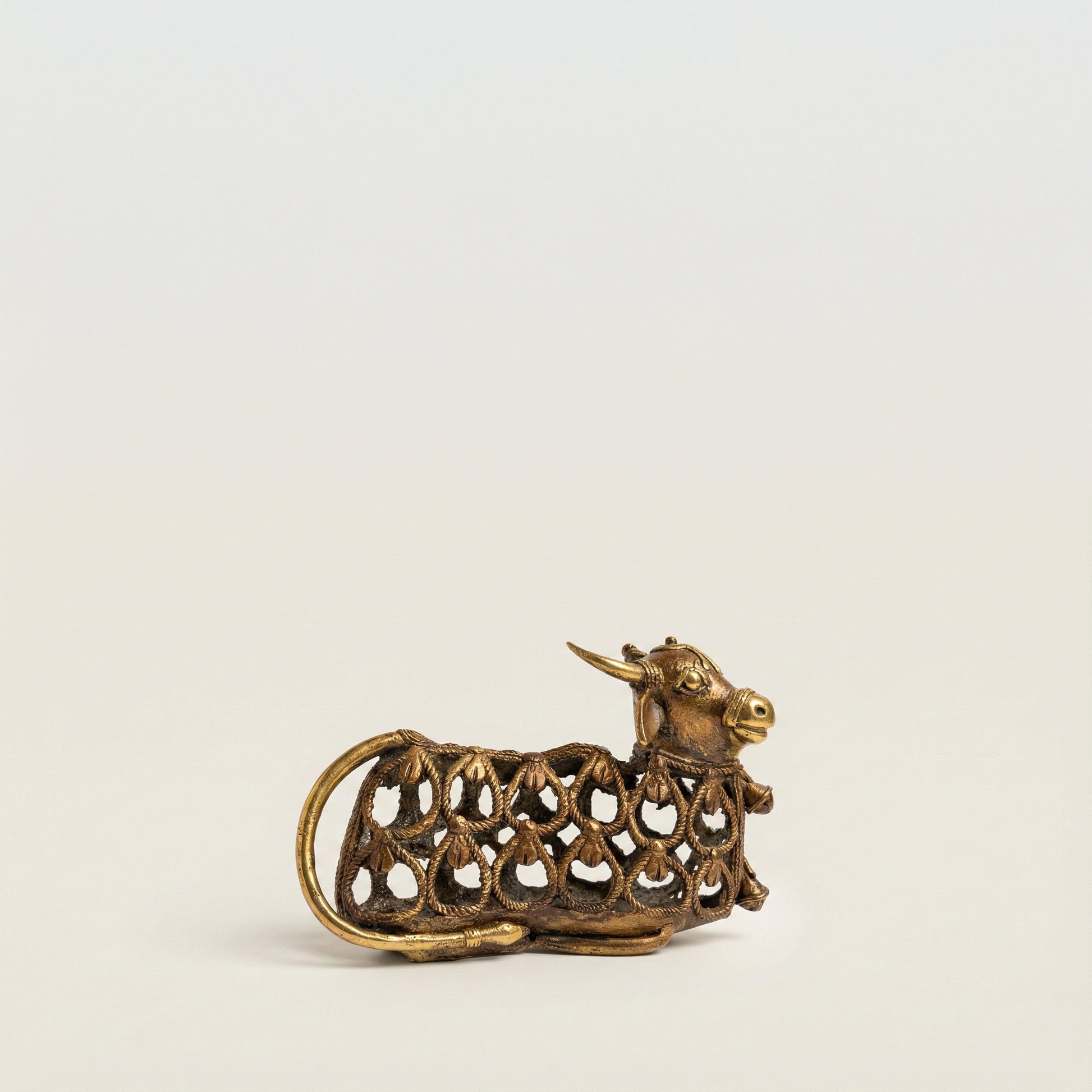 Side view of Nandi Dhokra bull sculpture showing full form and cast metal texture