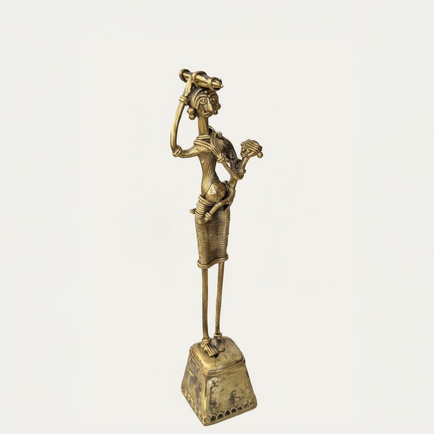 Side view of The Nurturing Mother Dhokra sculpture showing slender elongated form and cast metal texture