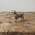 Pewter retriever figurine with raised tail and detailed coat, displayed on a rustic wooden surface