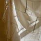 Detail of organic cotton throw showing hand-loomed weave and fringe, handcrafted by Leila Atelier South Africa