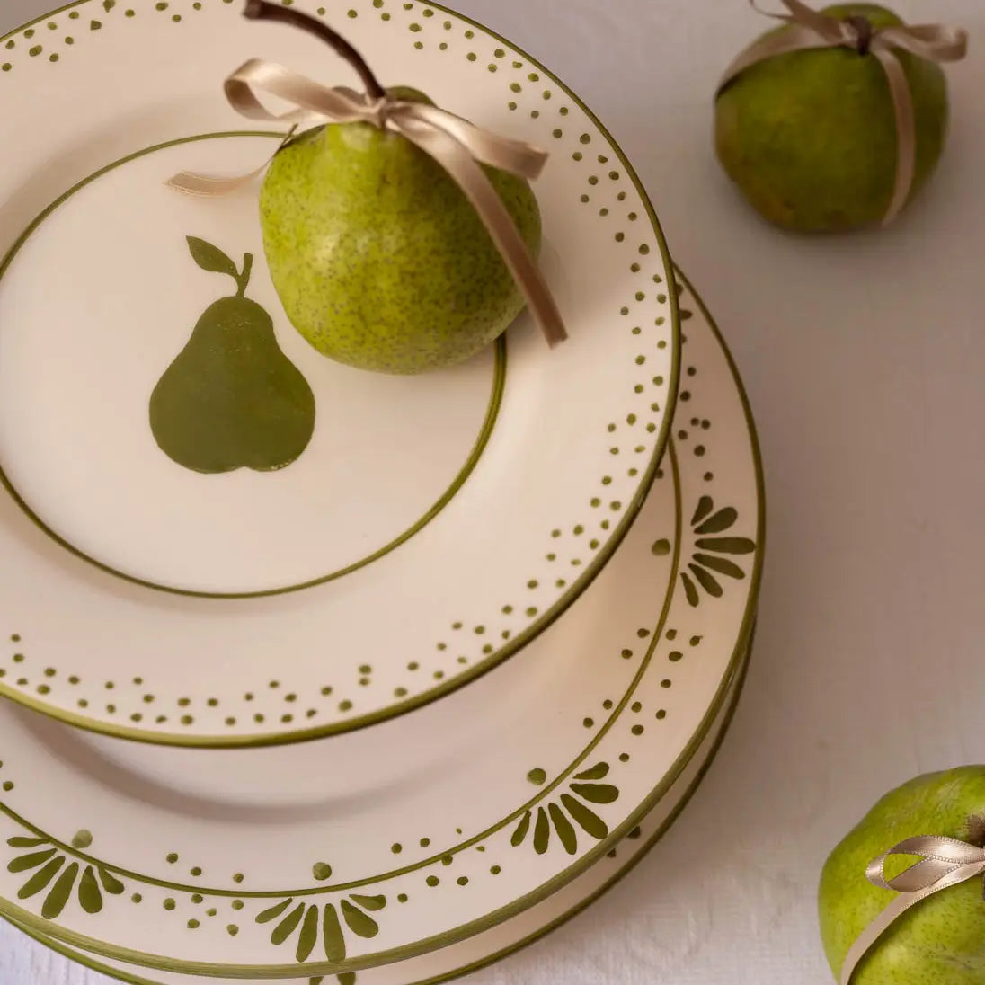 Hand-painted Portuguese dessert plate with pear motif styled with fresh pear, from Raquel Souza studio