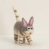 Hand-felted grey tabby cat with an upright striped tail, pink ears and wide eyes, on a white background
