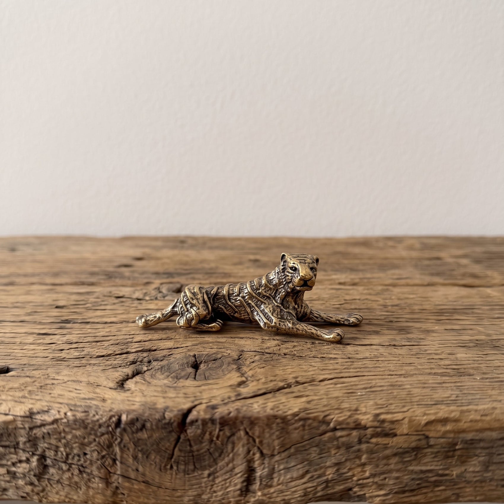 The Prowler miniature solid brass tiger figurine in a low prowling pose, finely striped with aged antique patina