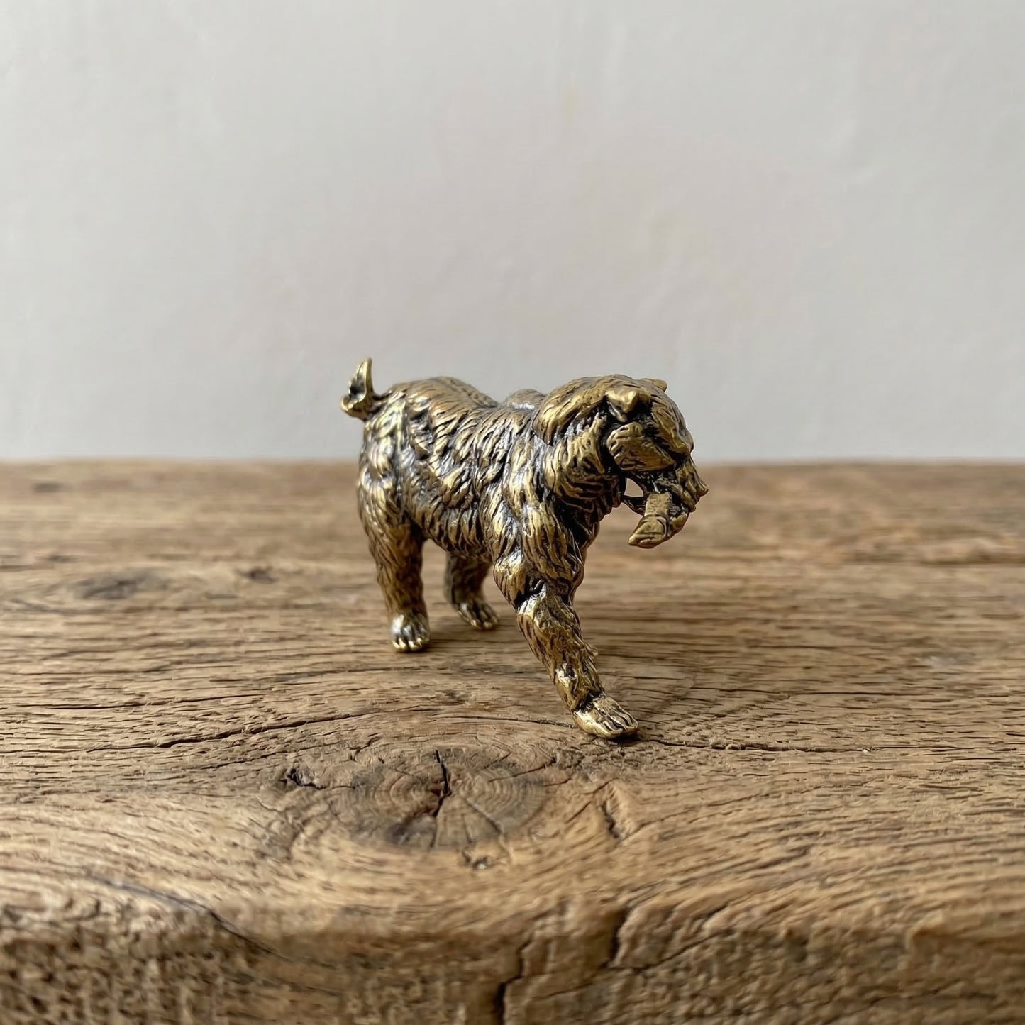 The Resilient Provider miniature brass polar bear carrying a fish, showing detailed fur texture and warm aged patina, from the WILLAGE Tiny Objects collection