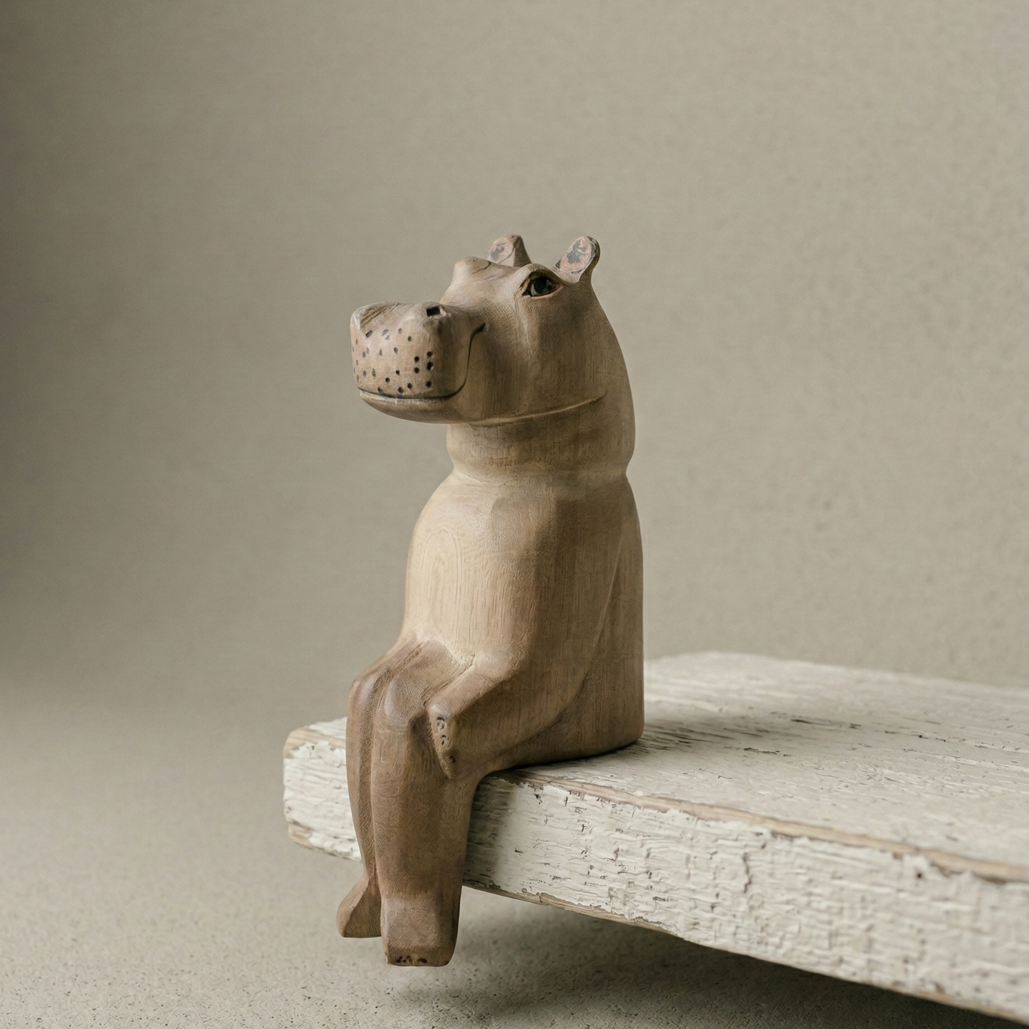 The Resting Hippo hand-carved wooden shelf sitter showing hand-painted detail and natural wood grain texture