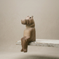 The Resting Hippo hand-carved wooden shelf sitter in a seated pose with dangling legs, carved from jacaranda wood by Kamba tribe artisans in Kenya, from WILLAGE