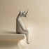 The Resting Rhino hand-carved wooden shelf sitter in a seated pose with dangling legs, carved from jacaranda wood by Kamba tribe artisans in Kenya, from WILLAGE