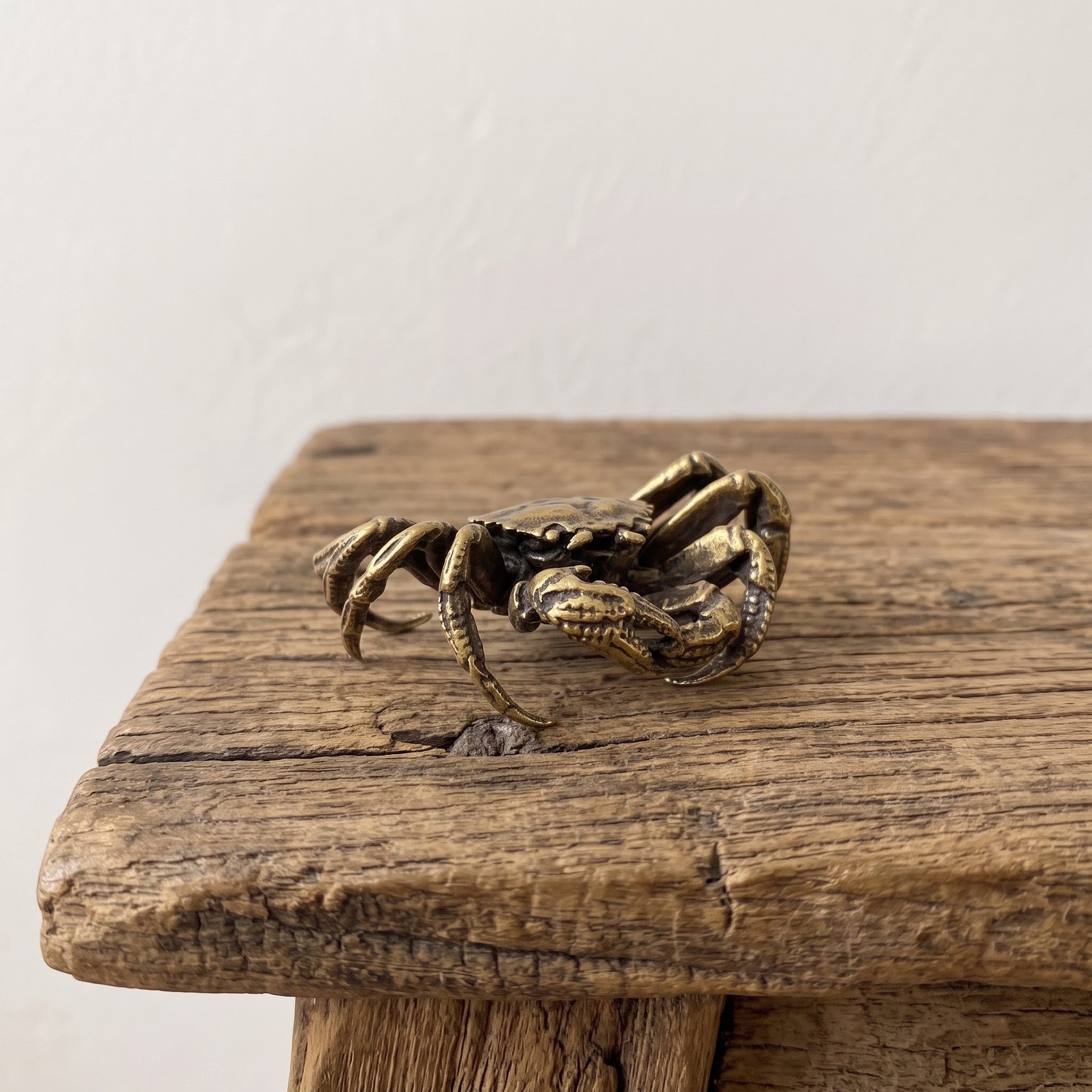 Brass mitten crab figurine with jointed legs and stippled shell, antique patina finish