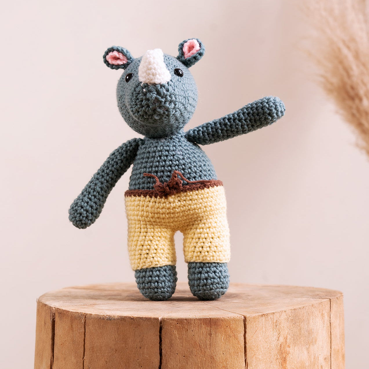 Hand-crocheted rhino amigurumi showing yarn detail, horn, and hand-stitched finish, from The Hobbyt India
