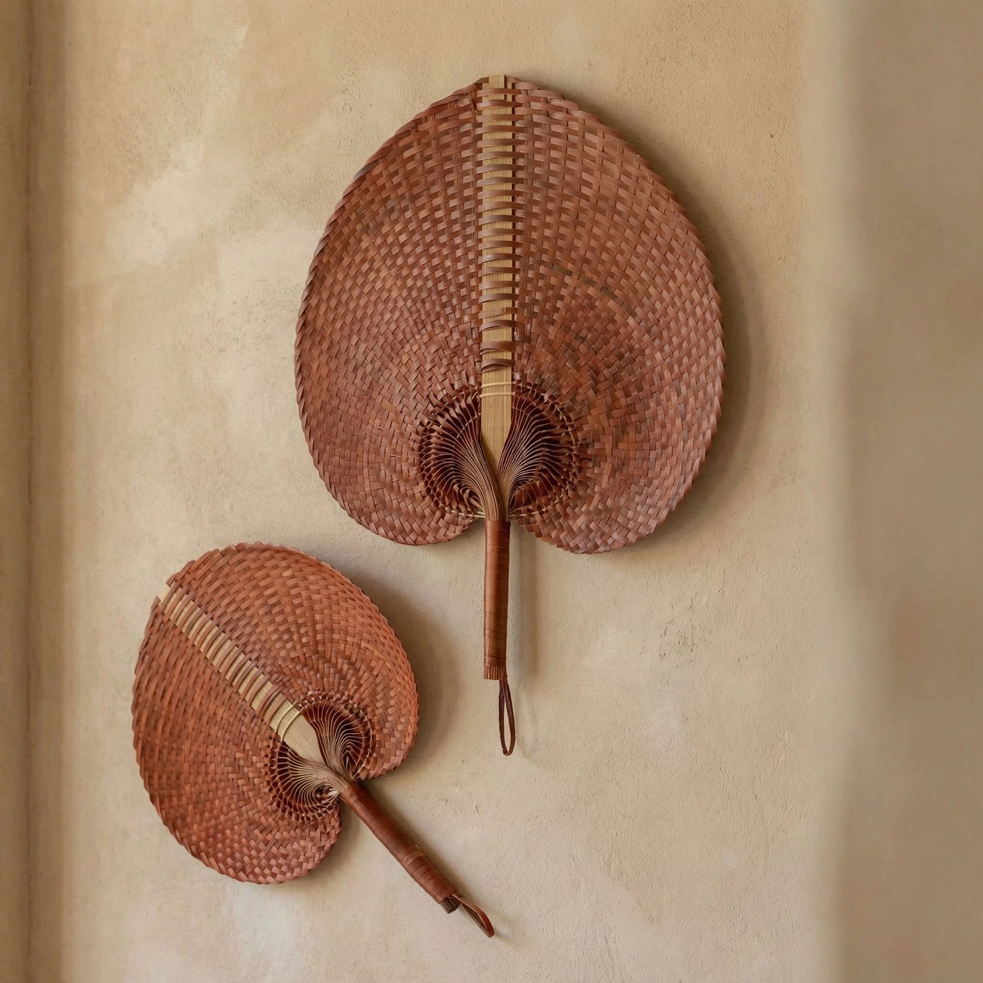 Handwoven rontal palm leaf fan with leather-wrapped handle, hand-braided by artisans in Bali Indonesia, from WILLAGE