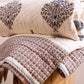 Folded hand block-printed cotton quilt from Jaipur showing umbrella motif, from WILLAGE