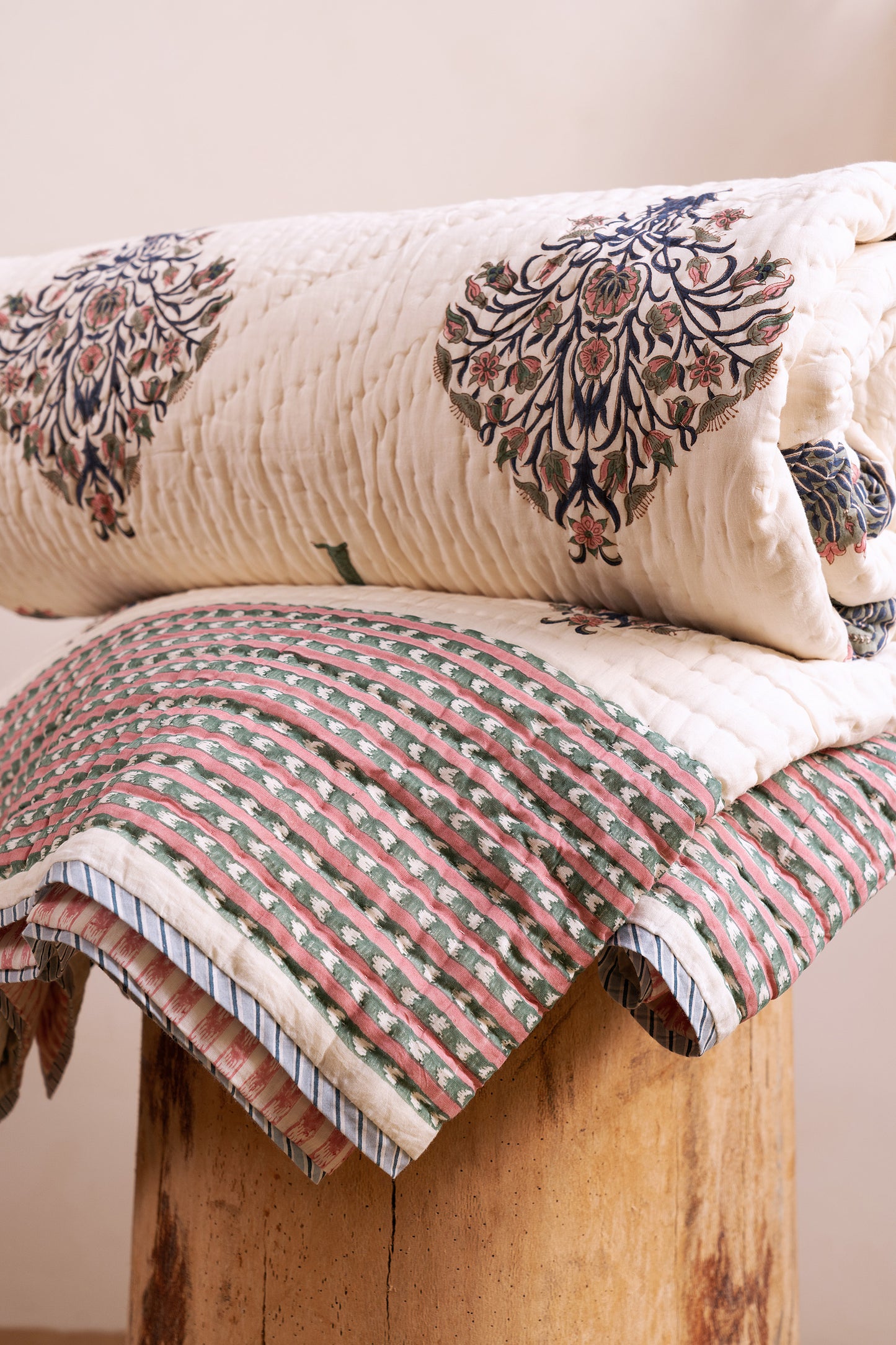 Folded hand block-printed cotton quilt from Jaipur showing umbrella motif, from WILLAGE