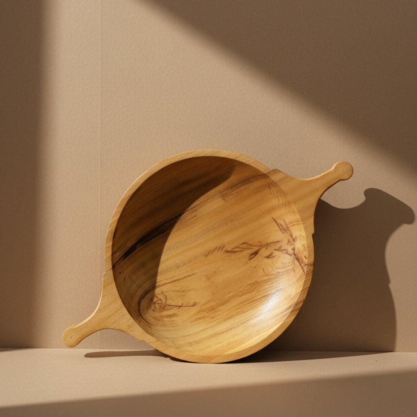 Top-down view of The Sakleshpur Bowl showing flowing jackfruit wood grain and integrated carved handles
