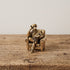 The Scholar miniature solid brass dog figurine reading a book in an armchair, with fine detail and aged antique patina
