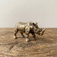 The Stand miniature solid brass rhino figurine with deeply textured folded hide and aged antique patina