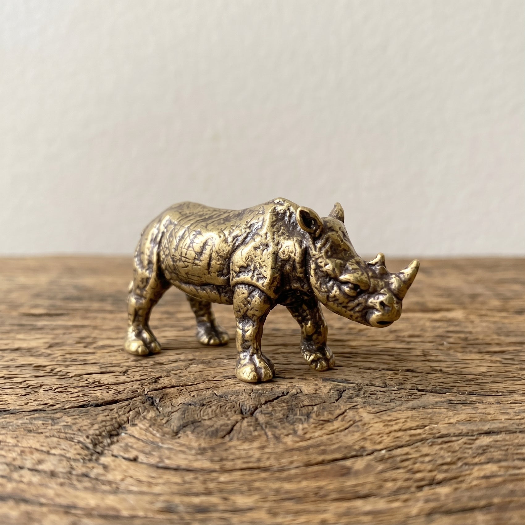 The Stand miniature solid brass rhino figurine with deeply textured folded hide and aged antique patina