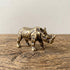 The Stand miniature solid brass rhino figurine with deeply textured folded hide and aged antique patina