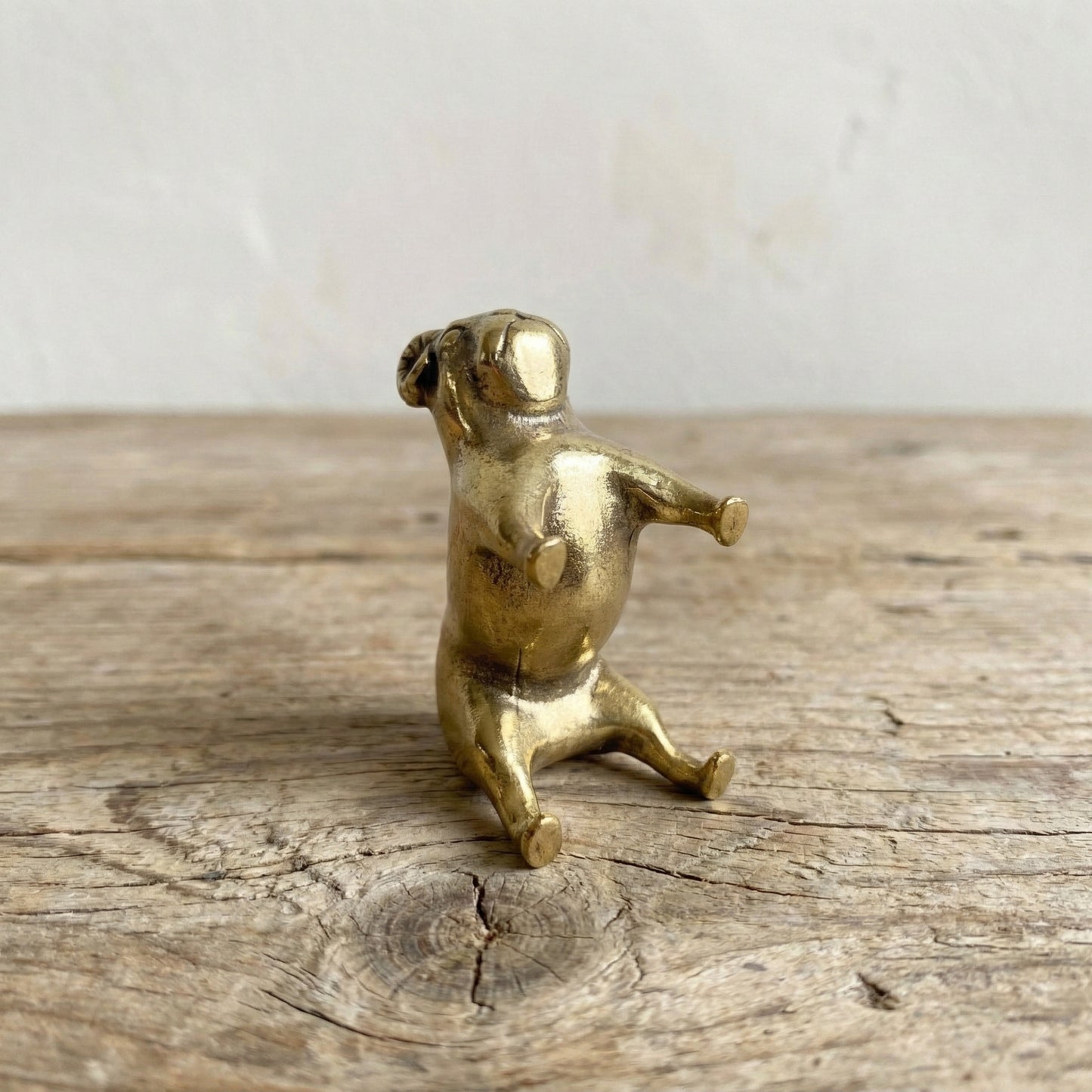The Steadfast Companion miniature brass bulldog from a side angle showing muscular stance and patina detail