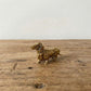 The Still Walker miniature brass dachshund figurine in walking pose showing elongated body and short legs, solid brass with aged patina, from WILLAGE Tiny Objects collection