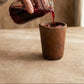 Two Sung Cup black clay tumblers side by side showing variation in tone and hand-formed shape