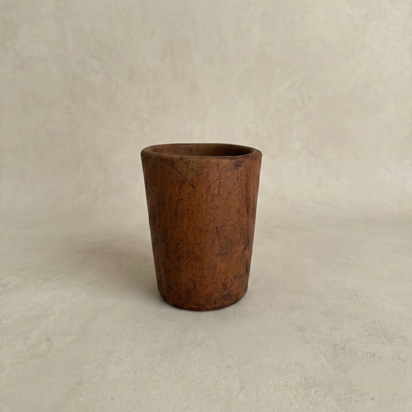 Sung Cup handleless black clay tumbler showing tapered form and natural tonal variation from fire, Lyrnai pottery from Meghalaya India, from WILLAGE