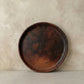 Sung dinner plate in handcrafted black clay showing wide flat form and burnished surface with natural tonal variation, Lyrnai pottery from Meghalaya India, from WILLAGE