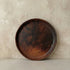 Sung dinner plate in handcrafted black clay showing wide flat form and burnished surface with natural tonal variation, Lyrnai pottery from Meghalaya India, from WILLAGE