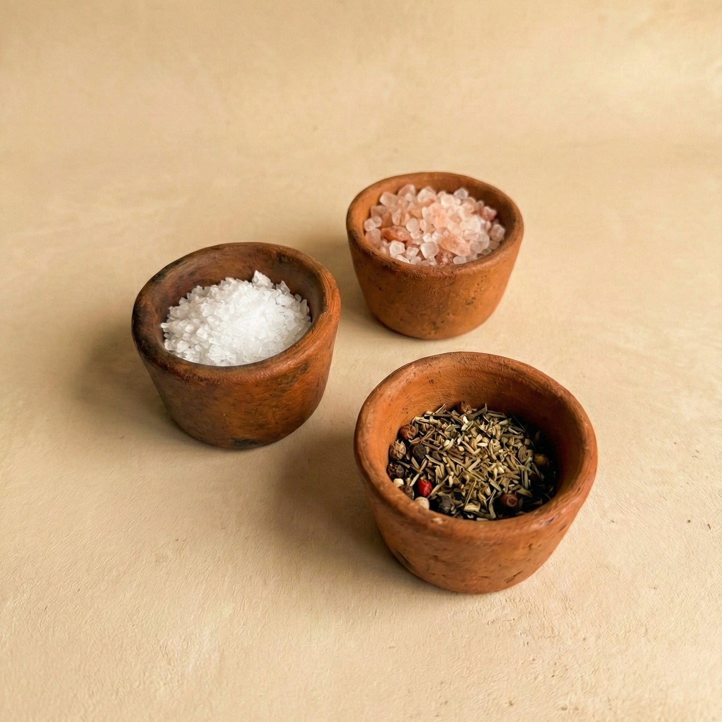 Multiple Sung Pinch Pots in black clay showing natural variation in form and size, handcrafted in the Jaintia Hills