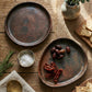 Sung black clay side plate displayed with other Sung Valley pottery on a wooden surface