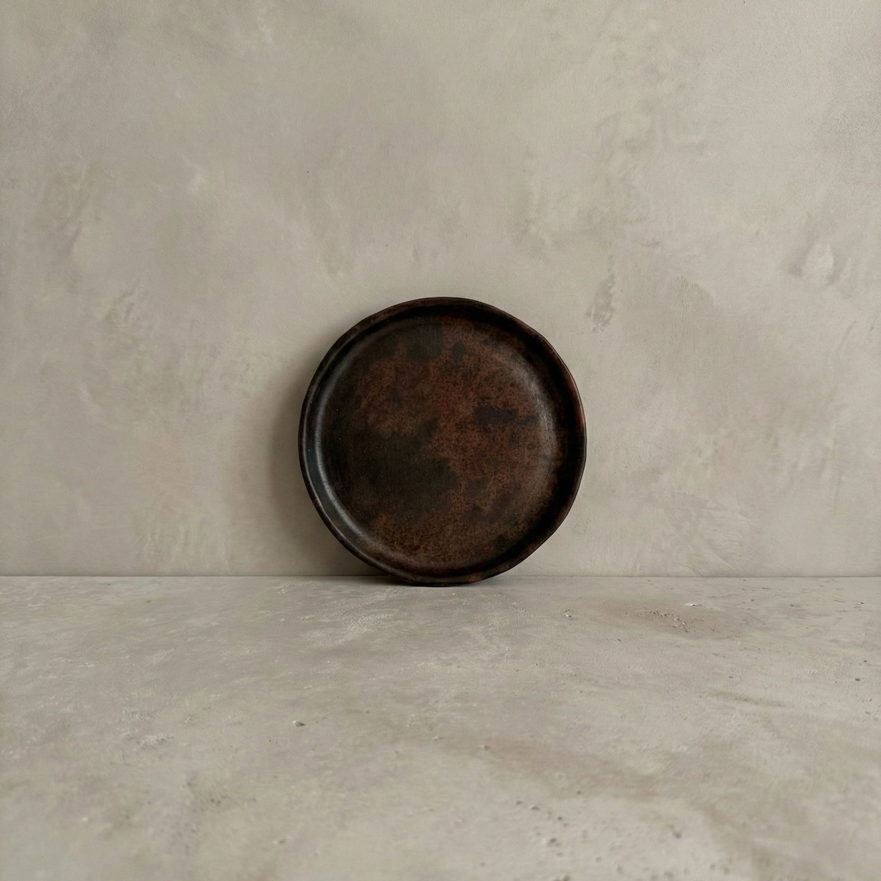 Sung side plate in handcrafted black clay showing rounded form and burnished surface, Lyrnai pottery from Meghalaya India, from WILLAGE
