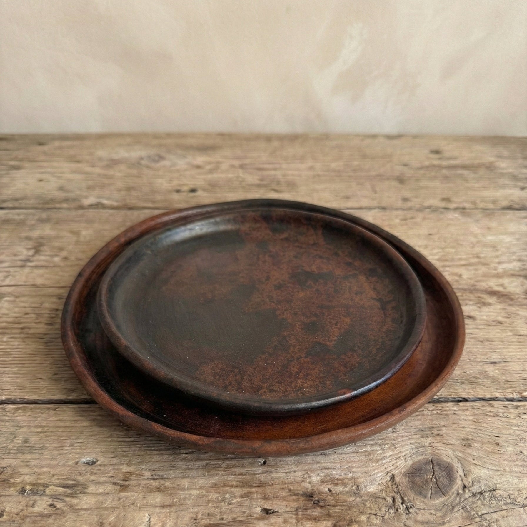 Stack of Sung Valley black clay plates showing variation in tone and hand-formed edges