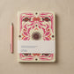 2027 weekly diary with a butter-yellow textured cover printed in magenta, rust and brown folk-art florals around a central dark sun, shown with its paper belly band