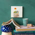 Taking My Time Storytile leaning on a styled shelf with books and ceramics, hand-baked ceramic tile by Marga van Oers in the Netherlands, from WILLAGE