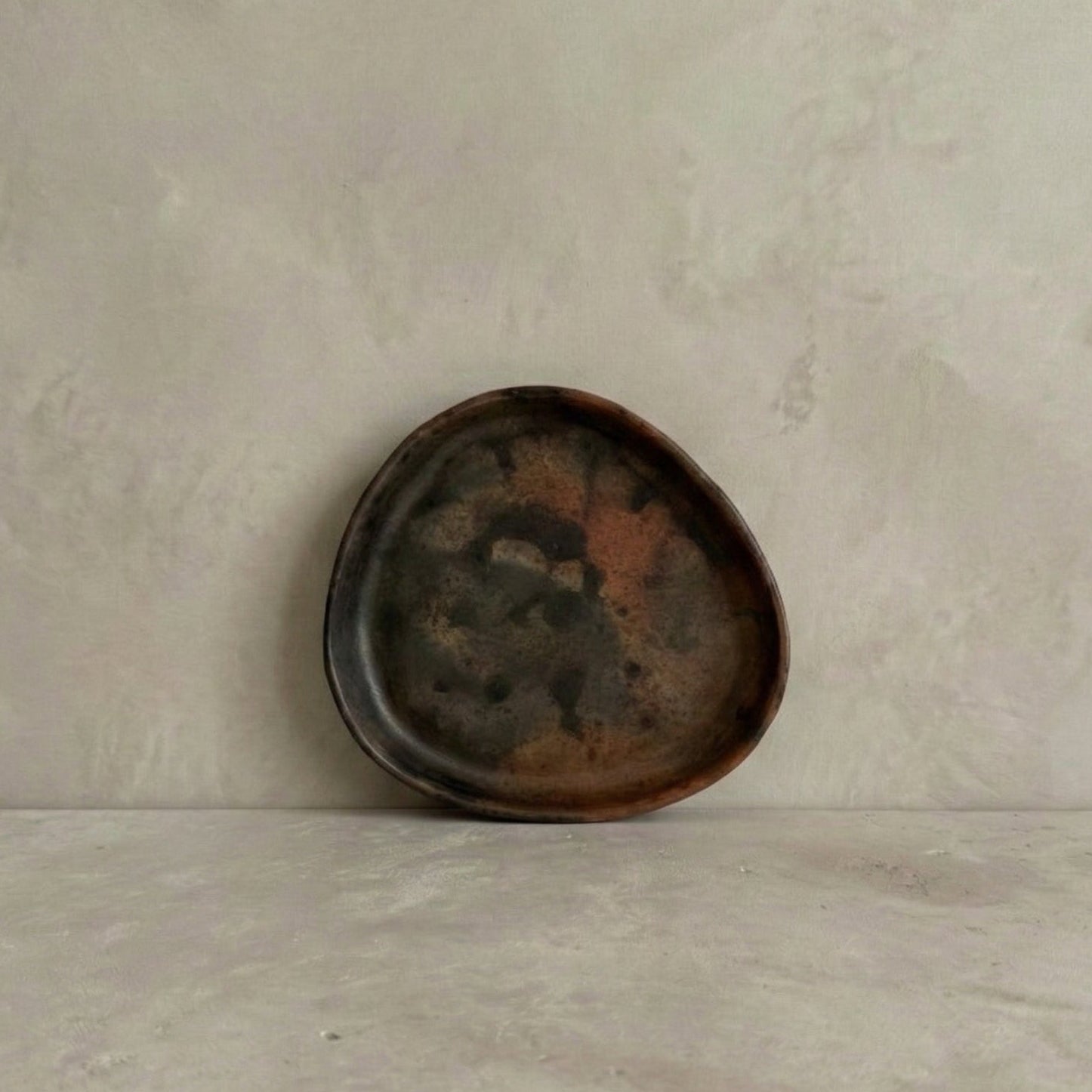 TriSung faceted triangle plate in handcrafted black clay showing organic triangular form and burnished surface, Lyrnai pottery from Meghalaya India, from WILLAGE