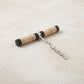 Pull-style corkscrew with a black mango wood and natural rattan wrapped handle and a stainless steel worm
